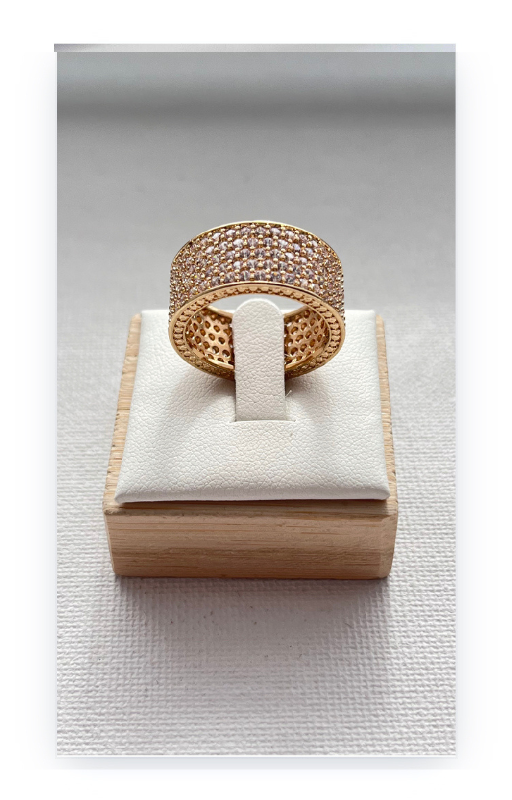 Ring in a band shape decorated with zircons, gold plated over copper base