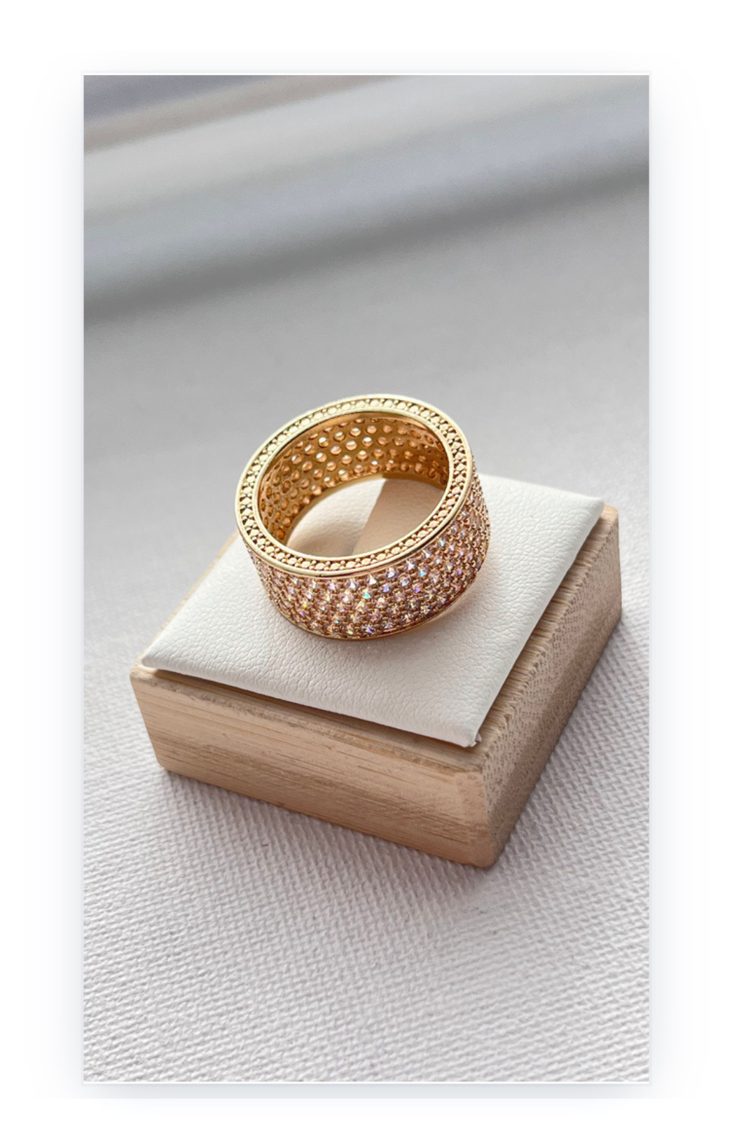 Ring in a band shape decorated with zircons, gold plated over copper base