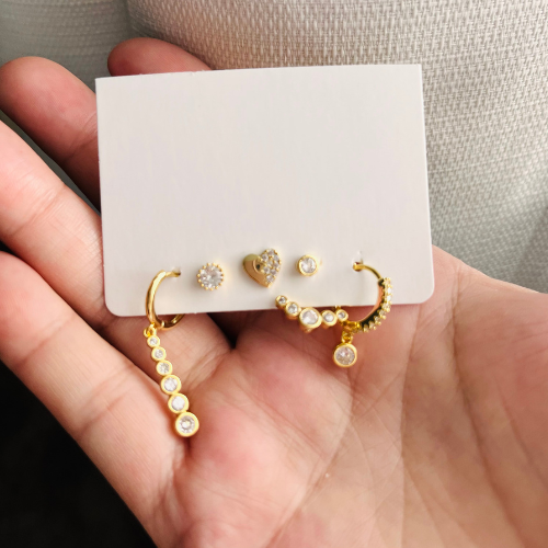 Small gold-plated hoops and dangle earrings.