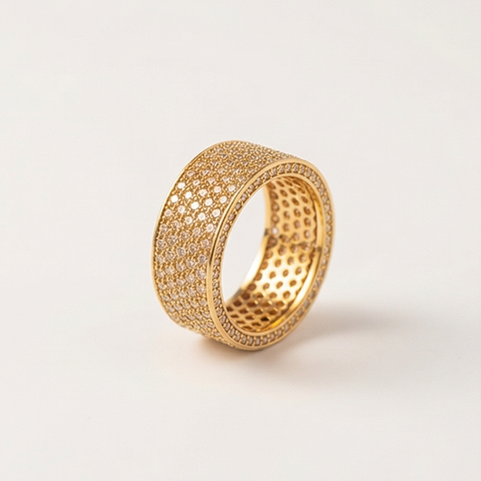 Ring in a band shape decorated with zircons, gold plated over copper base
