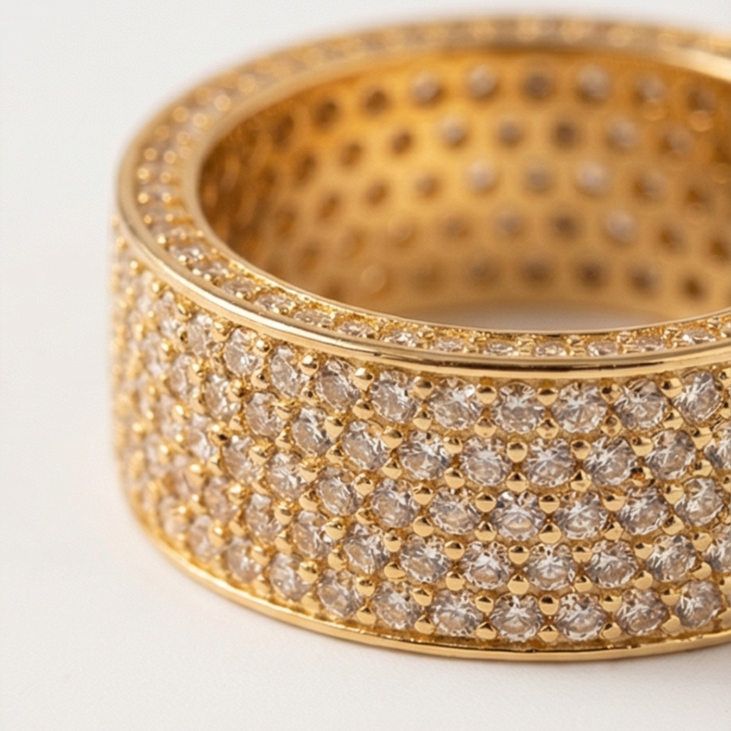 Ring in a band shape decorated with zircons, gold plated over copper base
