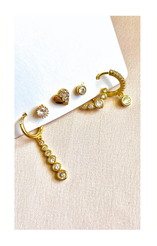 Small gold-plated hoops and dangle earrings.